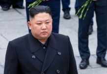 AI Weapons, ICBMs — Kim’s Terrifying Arsenal Expansion Person in dark coat standing on gray pavement