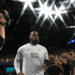 Basketball player entering arena with a crowd cheering