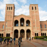 People walking outside a historic brick university building