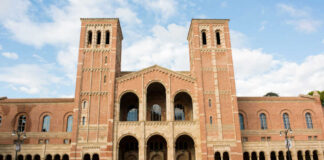 People walking outside a historic brick university building