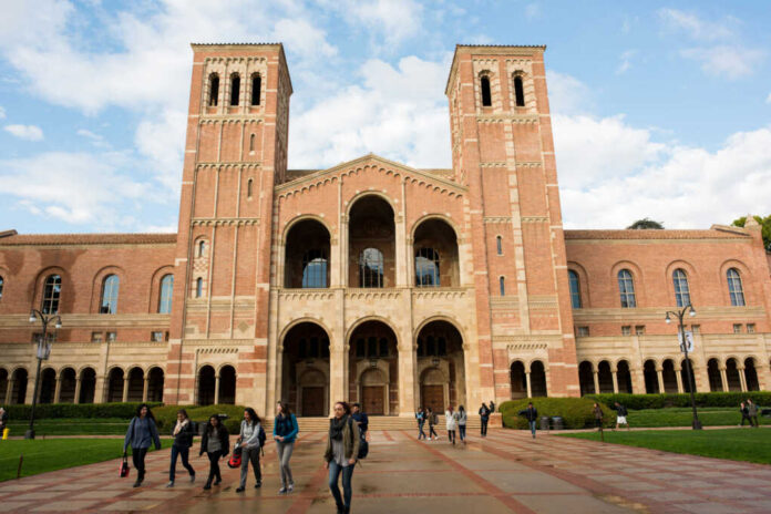 People walking outside a historic brick university building
