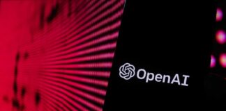 Close-up of a smartphone displaying the OpenAI logo against a vibrant digital background