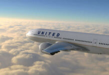 United Airlines’ Bold Move Amid Fuel Price Surge United airplane flying above clouds in the sky