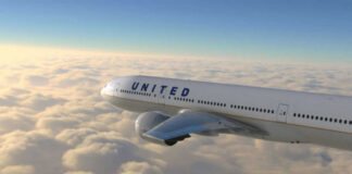 United airplane flying above clouds in the sky