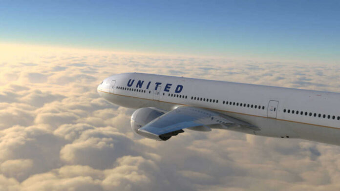 United airplane flying above clouds in the sky