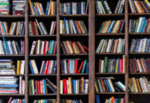 Library Bomb Threats: The New Campus Nightmare Books arranged on tall wooden shelves in a library