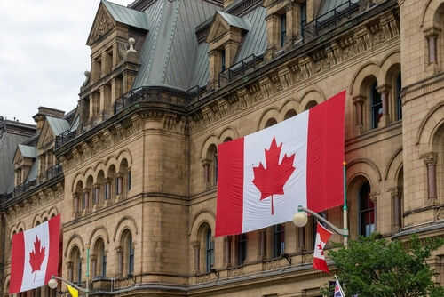 canada-gov2298721441 Historic building with large Canadian flags displayed outside