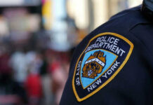 NYPD officer uniform badge closeup in NYC