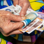 old woman holding money
