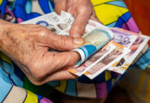 old woman holding money
