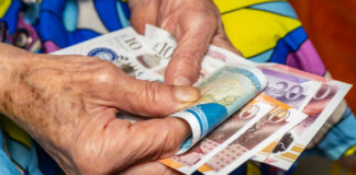 old woman holding money