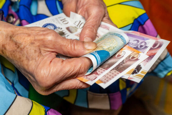 old woman holding money
