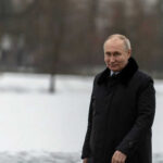 Putin’s Secret Proposals: Iran Peace Breakthrough? Person in dark coat standing on snowcovered ground