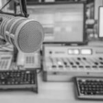 Microphone in radio studio with equipment visible