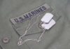 Ex-Marine’s Shocking Flag Stunt Sparks Fury Close-up of a U.S. Marines uniform with dog tags