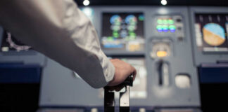 Pilot's hand operating the throttle in an aircraft cockpit