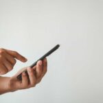 Shocking Fake News Fools Former U.S. Attorney Person using a smartphone with one hand