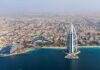 Aerial view of Dubai featuring the Burj Al Arab and surrounding buildings