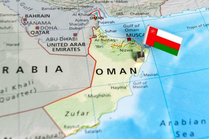 shutterstock_2594051521.jpg Map of Oman with a flag pin indicating its location