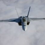 A fighter jet flying above the clouds