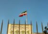 Beirut Blast: Iranian Diplomats Targeted Iranian flag waving above a government building against a blue sky