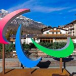 Colorful Paralympic symbol sculpture in a mountainous resort area