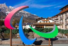 Colorful Paralympic symbol sculpture in a mountainous resort area