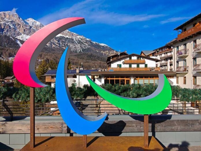 Colorful Paralympic symbol sculpture in a mountainous resort area