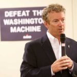 Rand Paul’s Surprising Restraint Amid Insult Drama A man speaking into a microphone at a campaign event