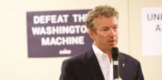 A man speaking into a microphone at a campaign event
