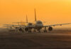 Airspace Chaos: Unbelievable Near-Miss at Major Airport Airplanes lined up on a runway during sunset