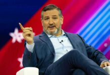 Person speaking on stage with colorful background