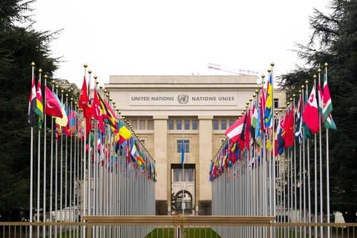united-nation2138662955 United Nations building with international flags displayed outside