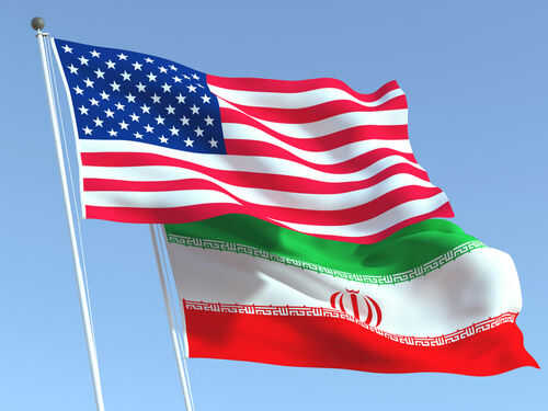 American and Iranian flags waving in the sky.