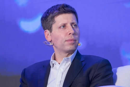sam-altman2366323229 Person wearing a suit with a microphone headset