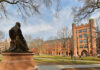 Statue overlooking a university campus with historic buildings