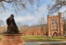 Statue overlooking a university campus with historic buildings
