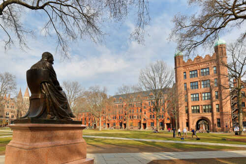 Statue overlooking a university campus with historic buildings