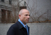 Fraudster Avenatti’s Sentence Slashed—Outrage Ensues A man in business attire walking in an urban area with a serious expression