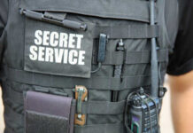 Close-up of a tactical vest worn by a security officer with 'SECRET SERVICE' label