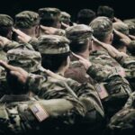 Group of soldiers in uniform saluting during a ceremony