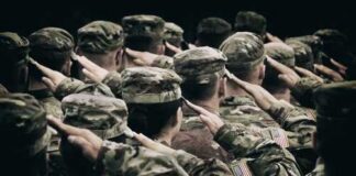 Group of soldiers in uniform saluting during a ceremony