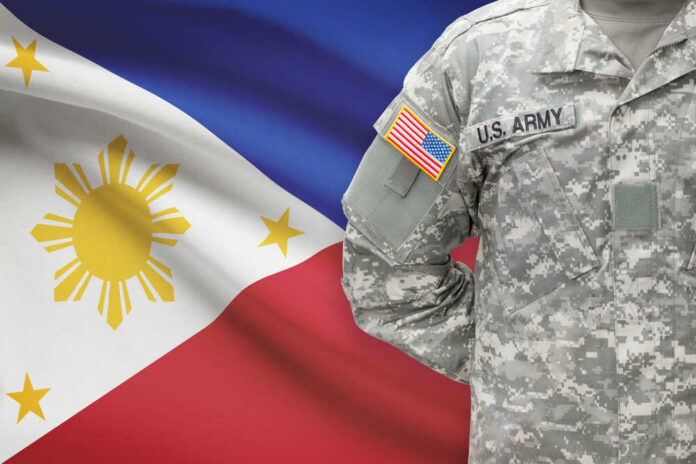 A soldier in a U.S. Army uniform with the Philippine flag in the background
