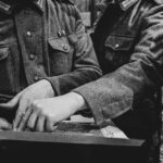 Soldiers in military uniforms examining a map together