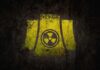 Yellow radiation symbol on a dark, textured background