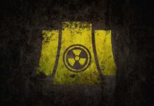 U.S. and Iran to “Dig Up” Nuclear Secrets Yellow radiation symbol on a dark, textured background