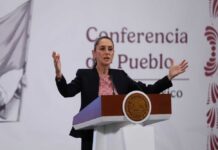 A government official speaking at a podium during a conference