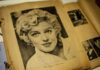 Black and white vintage photograph of a woman with curly hair, resembling Marilyn Monroe