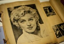 Black and white vintage photograph of a woman with curly hair, resembling Marilyn Monroe