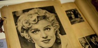 Black and white vintage photograph of a woman with curly hair, resembling Marilyn Monroe